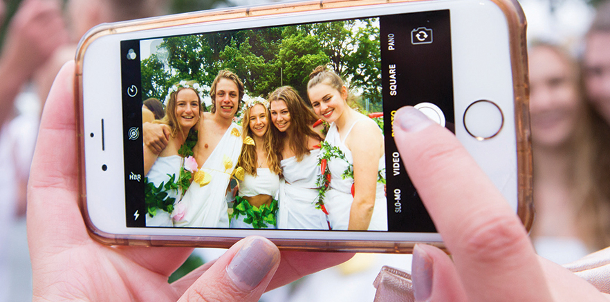 Student taking photo of other University of Otago students at the Toga Party during Orientation Week